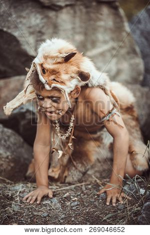 Caveman, Manly Boy Hunting Outdoors. Prehistoric Tribal Boy Outdoors On Nature. Young Shaggy And Dir