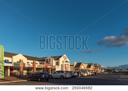 Langebaan, South Africa, August 20, 2018: A Sunset Street Scene, With Businesses And Vehicles, In La