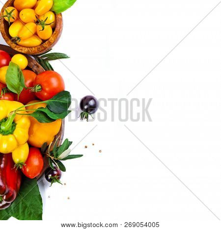 Assorted tomatoes and vegetables isolated on white background. Photo for your design