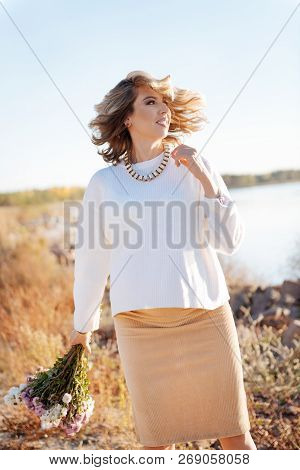 Pregnant Woman Holding A Bunch Of Flowers
