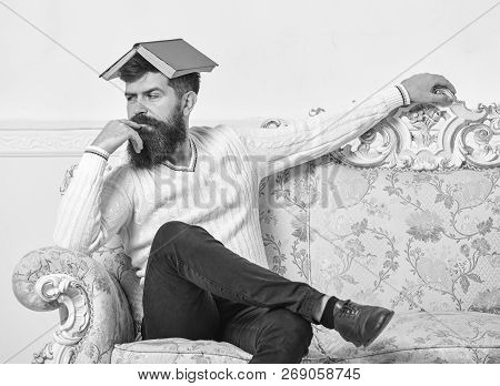 Macho Sits With Open Book On Head, Like Roof. Boring Literature Concept. Man With Beard And Mustache