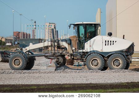 Saint Petersburg, Russia - August 31, 2017 A White Tractor Is Building A Road