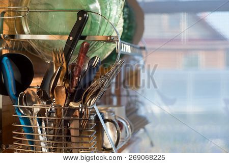 Home Kitchen. Clean Washed Dish Ware Drying On A Drainer Mounted In Kitchen. Clean Dishes: Spoon, Pl