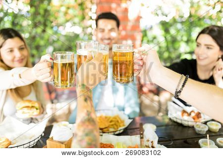 Male And Female Besties Having A Celebration With Beer At Burger Shop