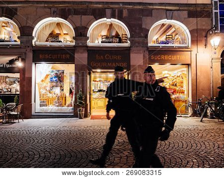 Strasbourg, France - Nov 29, 2017: Front View Of Two Police Officers In Front Of Candy Sweets Shop I