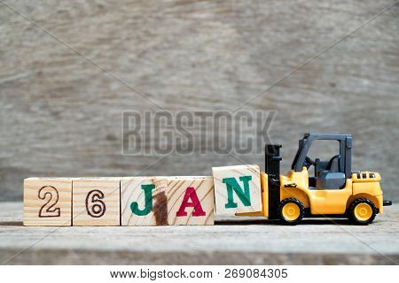 Toy Forklift Hold Block N To Complete Word 26jan On Wood Background (concept For Calendar Date In 26