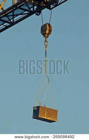 Rusty Toolbox Hanging Off A Construction Crane Attached By Steel Ceble And Hook