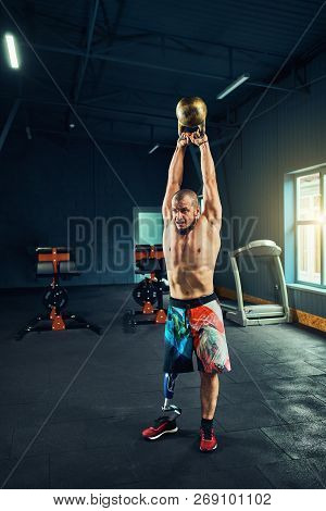 Sportsman With Prosthesis Working Out In Gym
