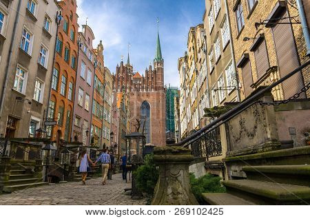Couple Walk Along Mariacka Street With Typical Colorful Houses Buildings Near Basilica Blessed Virgi
