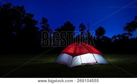Nylon Tent In North Carolina With Lights Inside And Stars Above