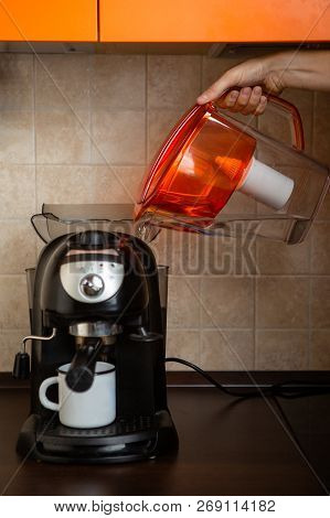 Photo Of Hand Of Man Pouring Water From Jug Into Coffee Maker In Kitchen