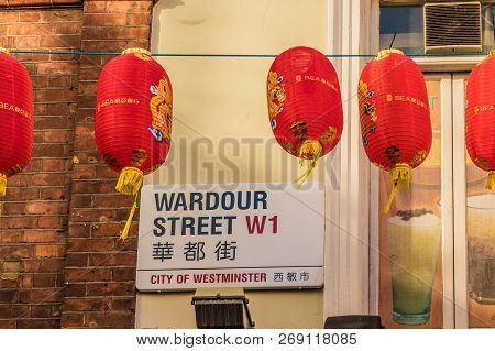 London. November 2018. A View Of A Street Sign For Wardour Street And Colourful Lanterns Hanging In 