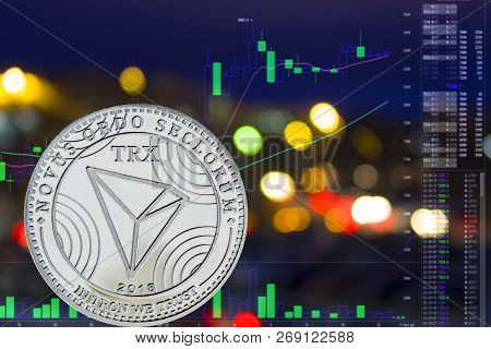 Coin Cryptocurrency Tron On Night City Background And Chart.