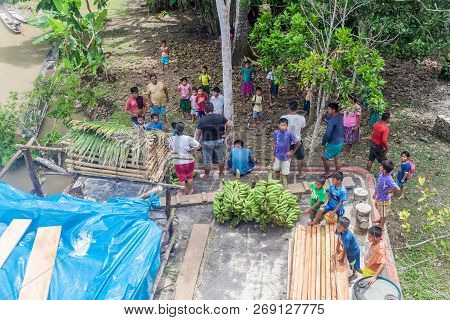 Napo, Peru - July 14, 2015: Cargo Boat Crew Transports Bunches Of Plantains To The Boat Deck. Cargo 