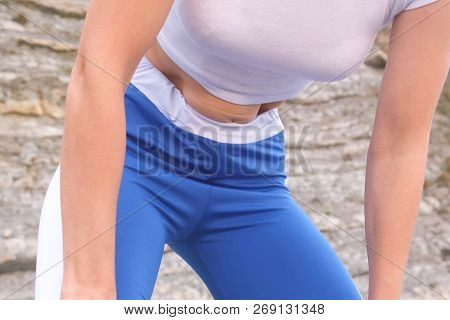 Flat Belly Girl During Diaphragmatic Breathing Exercises Bodyflex On The Rock Background. Belly Clos