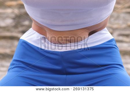 Flat Belly Girl During Diaphragmatic Breathing Exercises Bodyflex On The Rock Background. Belly Clos