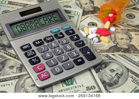 Obamacare Text Sign On Calculator Screen With Prescription Drugs And American Money
