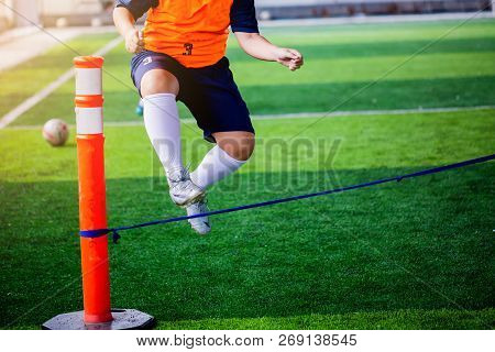 Boy Soccer Player Perform Coordination And Strength Drills By Jumping Over Rope.