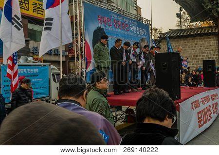 Seoul, South Korea; November 10, 2018: Unidentified Speakers Bow In Prayer At Rally Against The Moon