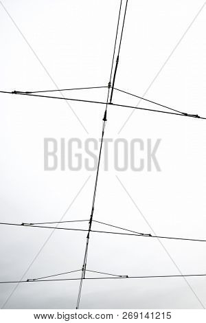 Detail of a catenary and stormy sky.