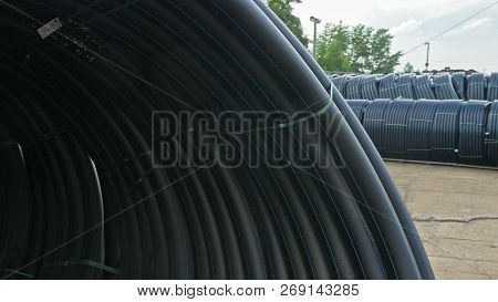 Warehouse Of Finished Plastic Pipes Industrial Outdoors Storage Site. Manufacture Of Plastic Water P