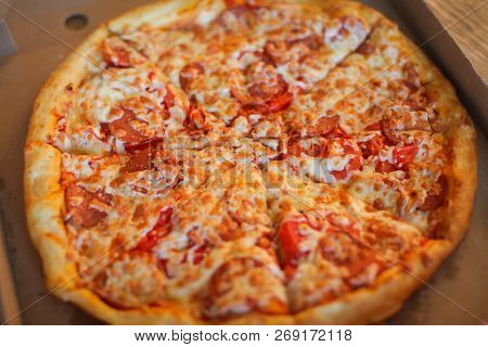 Slice Pizza In Box And Can Of Soda On Wood Background