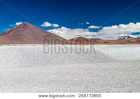 Borax Deposits At Laguna Colorada Lake With Mountain Peaks In The Background, Bolivia