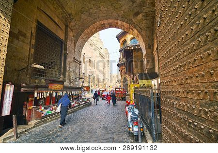Cairo, Egypt - December 21, 2017: The Cars And Pedestrians Use Narrow Historic Pass Through The Bab 