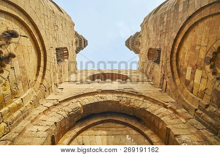 The Huge Stone Bab Zuwayla Gate With Carved Details And Tall Watchtowers, Cairo, Egypt.