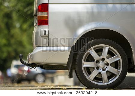 Close-up Side View Detail Of Silver Passenger Medium Size Luxury Minibus Van With Tow-bar Parked On 