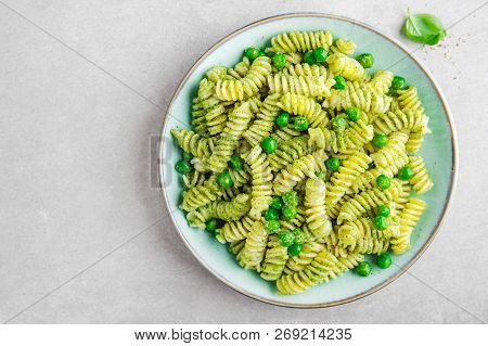 Tasty Appetizing Italian Pasta Al Bronzo With Pesto Sauce, Green Pea, Basil And Cheese Served On Pla