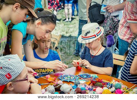 Zaporozhia/ukraine- June 2, 2018: Charity Family Festival-young Woman - Volunteer Explaining To Girl