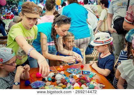 Zaporozhia/ukraine- June 2, 2018: Charity Family Festival-young Woman - Volunteer Explaining To Girl