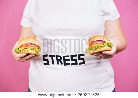 Stress, Eating Problems, Bulimia, Compulsive Overeating, Weight Gain. Overweight Woman With Two Burg