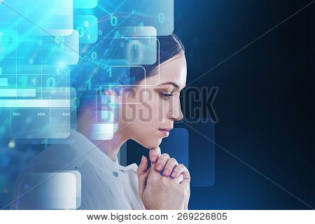 Pensive Young Businesswoman In White Standing Over Dark Blue Background With Double Exposure Of Digi