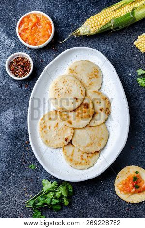 Colombian Food. Maize Arepas And Fried Pork Chicharron Ans Colombian Tomato Sauce. Top View. Black B