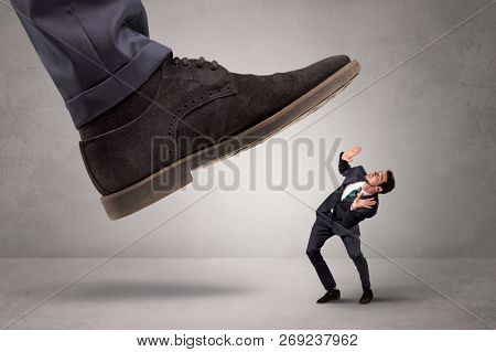 Young businessman illustrated inconsiderable by being trampled