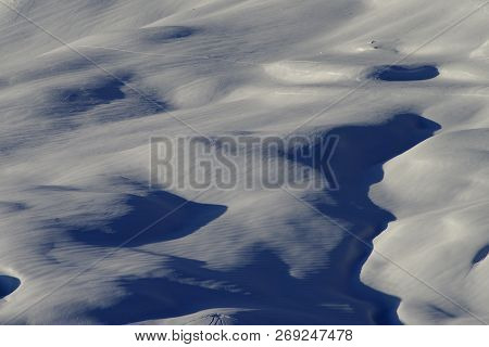 The Gentle Waves Of Snow Covered Hills In Evening Light