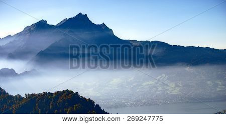 Mount Pilatus In Central Switzerland In Backlight Fog