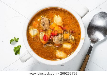 Goulash Soup On White Stone Table. European Cuisine. Top View Close Up.