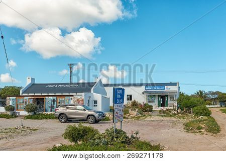 Paternoster, South Africa, August 21, 2018: A Street Scene, With Art Galleries And A Vehicle, In Pat