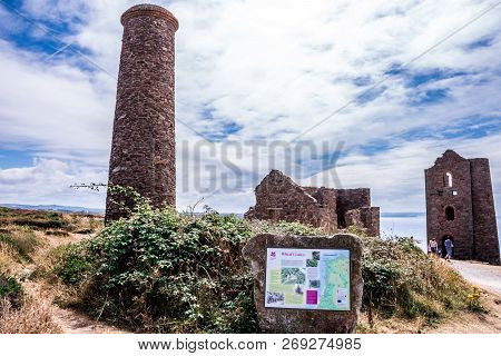 St. Agnes, England - July 24, 2018: Sign Of Stamps And Wheel Engine House Ruins Wheal Coates Mine On