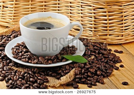 cup with coffee and coffee beans