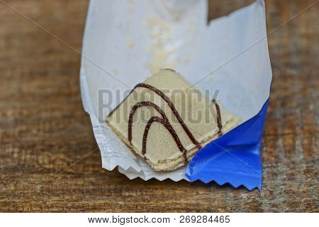Gray Candy From Waffles And Chocolate On A Paper Wrapper