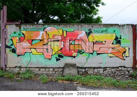 Full And Acomplished Graffiti Artwork. The Old Wall Decorated With Paint Stains In The Style Of Stre