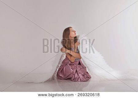 Girl In Pink Dress With Angel Wings On White Background. Angel-woman