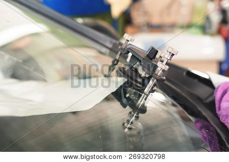 Close-up Of Polymer Vacuum Cracks Installed On A Cracked Windshield For Repairing Cracks And Chips