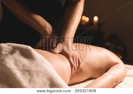 Close-up Male Hands Doing Healing Massage With Oil To A Young Girl In A Dark Cosmetology Office. Dar
