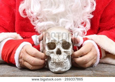 Santa Claus. Santa Claus holds a Human Skull. Santa finds an old Elf Skull. Old Man Winter is scared. Sold my soul to Santa. 