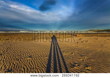 Bright sunset on the famous sandy Cannibal Beach. Shadows of photographers